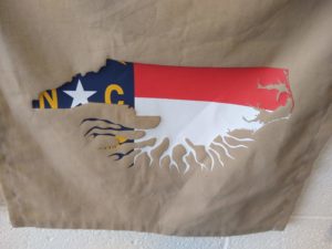 outline of the state of NC with roots